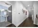 Hallway view of a bathroom with modern fixtures, a pedestal sink, and sleek gray door at 1100 Howell Mill Nw Rd # 708, Atlanta, GA 30318