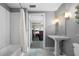 A neutral-toned bathroom showcases subway tiles, an open door to the bedroom, and a pedestal sink at 1100 Howell Mill Nw Rd # 708, Atlanta, GA 30318