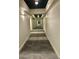 Long hallway with grey carpet, white walls, and ceiling lighting. Doors on both sides at 1100 Howell Mill Nw Rd # 708, Atlanta, GA 30318