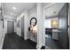 Modern home hallway features dark wood floors, grey doors and a glimpse into the living room at 1100 Howell Mill Nw Rd # 708, Atlanta, GA 30318