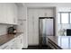 Kitchen featuring stainless steel refrigerator and white cabinets and dark wood floors at 1100 Howell Mill Nw Rd # 708, Atlanta, GA 30318