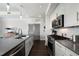 Modern kitchen with stainless steel appliances, white cabinets and dark countertops at 1100 Howell Mill Nw Rd # 708, Atlanta, GA 30318