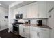 Modern kitchen featuring white cabinets, stainless steel appliances, and dark wood floors at 1100 Howell Mill Nw Rd # 708, Atlanta, GA 30318