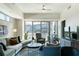 Cozy living room with large windows, comfortable seating, and city views providing a bright and airy space at 1100 Howell Mill Nw Rd # 708, Atlanta, GA 30318