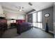 Comfortable bedroom features a large window, ceiling fan, carpet and stylish decor at 1100 Howell Mill Nw Rd # 708, Atlanta, GA 30318