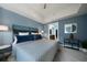 Stylish bedroom features blue walls, ceiling fan, and ensuite bathroom creating a calm and inviting space at 1100 Howell Mill Nw Rd # 708, Atlanta, GA 30318