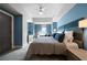 Serene bedroom with blue walls, plush bedding, a ceiling fan, and ample natural light; providing a relaxing retreat at 1100 Howell Mill Nw Rd # 708, Atlanta, GA 30318