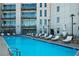 Relaxing pool area with lounge chairs, umbrellas, and building views for a resort-like feel at 1100 Howell Mill Nw Rd # 708, Atlanta, GA 30318
