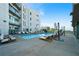Inviting outdoor pool with comfortable lounge chairs, umbrellas, and a modern building backdrop at 1100 Howell Mill Nw Rd # 708, Atlanta, GA 30318