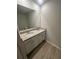 Bathroom featuring a double sink vanity with granite countertops, modern fixtures and a large mirror at 111 Woodside Ct, Temple, GA 30179