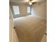 Large bedroom with neutral carpet, ceiling fan and natural light provided by two windows at 111 Woodside Ct, Temple, GA 30179