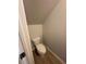 Small, enclosed toilet area, featuring a classic white toilet and neutral wall color at 111 Woodside Ct, Temple, GA 30179