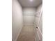 Walk-in closet with carpet and a wire rack for storage at 111 Woodside Ct, Temple, GA 30179