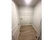 Walk-in closet featuring a wood look floor and wire shelving at 111 Woodside Ct, Temple, GA 30179