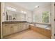 Bathroom with large soaking tub and double sink vanity at 130 Staddlebridge Ave, Canton, GA 30114