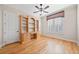 Bright bedroom with hardwood floors, wooden built-ins, and plantation shutters at 130 Staddlebridge Ave, Canton, GA 30114