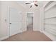 Cozy carpeted bedroom featuring ceiling fan, and closet at 130 Staddlebridge Ave, Canton, GA 30114