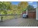 Outdoor deck area perfect for grilling with privacy fence and lush trees at 130 Staddlebridge Ave, Canton, GA 30114