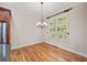 Bright dining area with hardwood floors, chandelier, and natural light from large windows at 130 Staddlebridge Ave, Canton, GA 30114