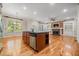 Open kitchen and living area with island, stone fireplace, and built-in shelving at 130 Staddlebridge Ave, Canton, GA 30114