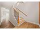 Staircase with wooden steps, black iron railings, and natural light for a welcoming ambiance at 130 Staddlebridge Ave, Canton, GA 30114