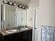 Bathroom featuring a double vanity, granite countertops, large mirror, and modern lighting at 2190 Bridgewater Pass, Hampton, GA 30228