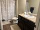 Traditional bathroom with dark wood vanity, decorative shower curtain, and white sink at 2190 Bridgewater Pass, Hampton, GA 30228