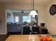 Open-concept dining area featuring a wooden table and stylish pendant lighting, seamlessly connects to the adjacent living room at 2190 Bridgewater Pass, Hampton, GA 30228