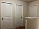 Hallway with three white doors and neutral colored walls, well-lit and clean at 2190 Bridgewater Pass, Hampton, GA 30228