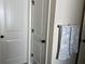 Hallway features white doors with black hardware and a towel rack holding white and grey towels at 2190 Bridgewater Pass, Hampton, GA 30228