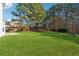 Expansive backyard with lush green lawn and mature trees, perfect for outdoor entertaining at 4030 Brushy Creek Way, Suwanee, GA 30024