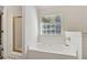 Bathroom with an inviting soaking tub and an enclosed glass door shower at 4030 Brushy Creek Way, Suwanee, GA 30024