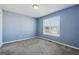 Bedroom with new plush carpet and blue walls and great natural light at 4030 Brushy Creek Way, Suwanee, GA 30024