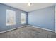 Bedroom with new plush carpet and blue walls with great natural light at 4030 Brushy Creek Way, Suwanee, GA 30024