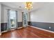 Well-lit dining room with hardwood floors, blue decorative curtains, and neutral walls at 4030 Brushy Creek Way, Suwanee, GA 30024