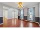 Elegant dining room with hardwood floors, blue decorative curtains, and adjacent rooms at 4030 Brushy Creek Way, Suwanee, GA 30024