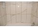 Modern bathroom bathtub with white and grey marble tile at 2568 Loghaven Nw Dr, Atlanta, GA 30318