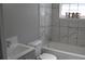 This bathroom features white marble-look tile, a gray vanity, and sleek fixtures at 2568 Loghaven Nw Dr, Atlanta, GA 30318