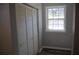 Neutral bedroom with a window and a closet at 2568 Loghaven Nw Dr, Atlanta, GA 30318