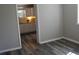 Bedroom featuring grey wood-look flooring and a glimpse into the white kitchen at 2568 Loghaven Nw Dr, Atlanta, GA 30318
