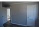 This bedroom features neutral walls and stylish dark gray wood flooring, an entrance to the bathroom at 2568 Loghaven Nw Dr, Atlanta, GA 30318