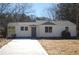 Charming single-story home with a well-manicured front yard and a freshly paved concrete driveway at 2568 Loghaven Nw Dr, Atlanta, GA 30318