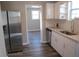 Well-lit kitchen with stainless steel appliances and view to an adjacent room at 2568 Loghaven Nw Dr, Atlanta, GA 30318