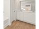 Stylish bathroom with a double vanity, wooden floors, and modern fixtures at 4167 Viola Pl, Atlanta, GA 30349