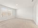 Bright bedroom with a neutral carpet, window, and a clean, minimalist design at 4167 Viola Pl, Atlanta, GA 30349