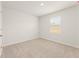Cozy bedroom featuring neutral carpet, light walls, and a window with natural light at 4167 Viola Pl, Atlanta, GA 30349