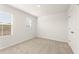 Bright bedroom with neutral carpet, white walls, and natural light from two windows at 4167 Viola Pl, Atlanta, GA 30349