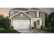 Two-story home features green siding, white trim, a two-car garage and charming front entry at 4167 Viola Pl, Atlanta, GA 30349