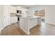 Bright kitchen features white cabinets, granite counters, stainless appliances and island with sink at 4167 Viola Pl, Atlanta, GA 30349