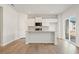 Light kitchen showcases island with granite countertops, white cabinetry, and stainless appliances at 4167 Viola Pl, Atlanta, GA 30349